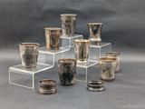 many cups that are sitting on a clear stand