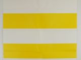 yellow and white striped wall hanging on a white wall