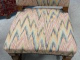 a chair that has been upholstered with a colorful pattern on it