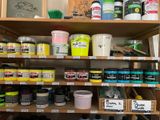 a shelf full of paint and other paints in a store