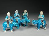 six chinese figurines of men riding on horses and a cow