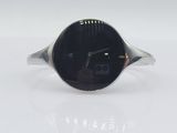 silver ring with a black face and a black face on it
