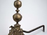 an antique brass candle holder on a stand with a bird on top