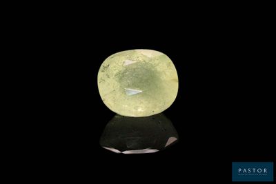 a green quartz stone on a black surface