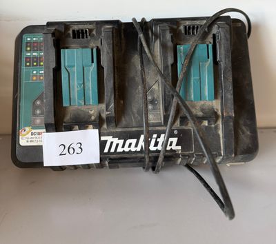 two makita batteries that are connected to a charger
