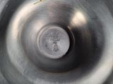 a close up of a metal bowl with a metal lid