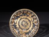 a close up of a plate on a table with a black background