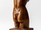 wooden sculpture of a female torso on a wooden block