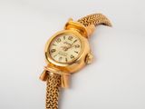 an image of a close up of a wrist watch on a white surface