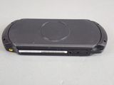 a black cell phone sitting on top of a table