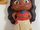 a small figurine of a girl in a dress