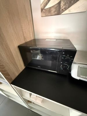un micro-ondes posé sur un plan de travail, à côté d'un four à micro-ondes