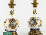 pair of vases with gold and blue designs on them on a white surface