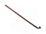 a close up of a wooden stick on a white surface