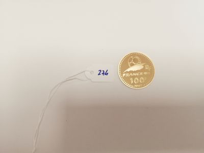 a gold coin on a white plate with a white cord