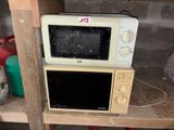 a microwave that is sitting on top of a wooden shelf