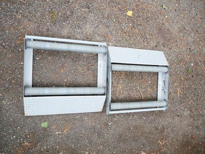 a broken window frame on the ground next to the ground