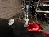 a red hat sitting on top of a table next to a lamp