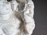 statue of a seated woman holding a baby in her arms