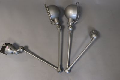four metal spoons sitting on top of a table