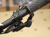 a close up of a bike handle with a black handlebar