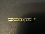 a close up of a metal chain on a black surface