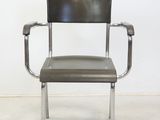 an image of a metal chair with a leather seat in a room