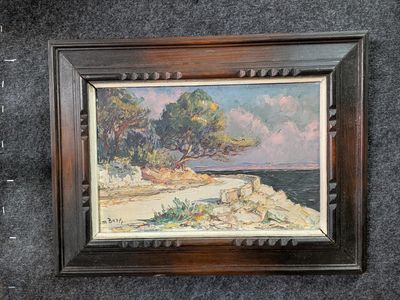 tableau représentant une scène de plage avec des arbres et des rochers, dans un cadre en bois
