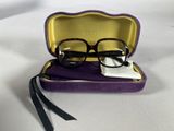 glasses in a case on a table with a white cloth