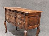 an old wooden chest of drawers with a drawer on top of it