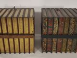 pair of antique books in wooden boxes on a white surface