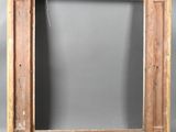 an old wooden frame with a hole in the middle of it