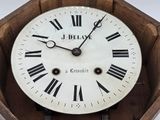 clock with roman numerals and roman numerals in a wooden box