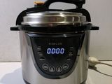 an electric pressure cooker sitting on top of a counter top
