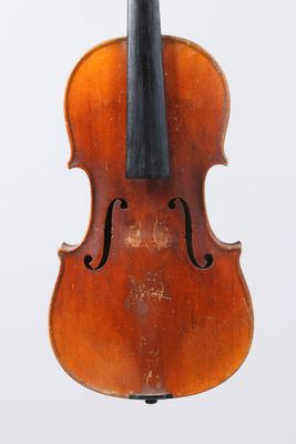 un vieux violon posé sur une surface blanche