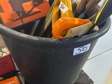 a bucket full of scissors and other office supplies on a table
