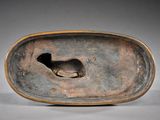 a bronze sculpture of a bird on a plate