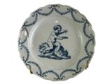 a blue and white plate with a picture of a child on it