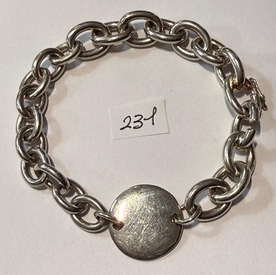 a silver bracelet with a silver button on it
