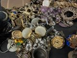 a pile of assorted jewelry sitting on a table