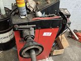 a machine that is sitting on the ground next to a trash can