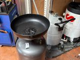 a large frying pan sitting on top of a metal container