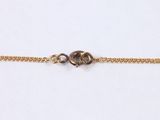 a gold chain bracelet with a skull on it
