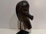 sculpture of a man ' s head with a pipe in his mouth