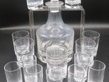 many glasses and a decanter sitting on a table