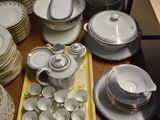 a lot of plates and bowls on the table