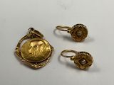 three pieces of gold jewelry including a coin and a ring