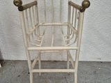 a white chair that is sitting on a concrete floor