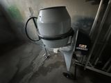 a white mixer sitting on a cart in a room