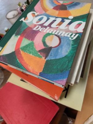 a stack of books sitting on top of a wooden table
